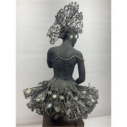 Composite bronzed sculpture, modelled as a ballerina, the skirt and head dress 
 set with glass cabochons, upon a rectangular wooden plinth, H92cm