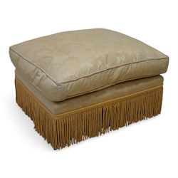 20th century hardwood-framed rectangular footstool with loose cushion, upholstered in floral pattern gold silk fabric with fringe, turned feet on brass castors 