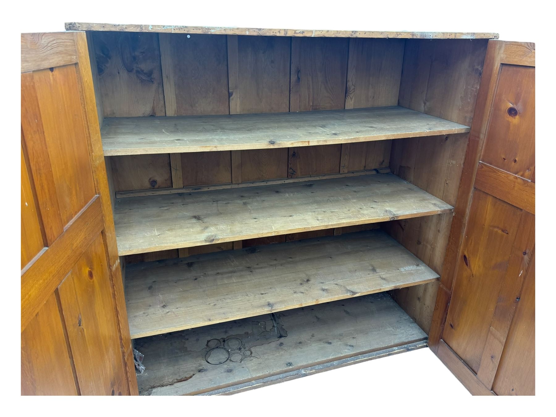 Large 19th century pine cupboard, rectangular top over two panelled later doors, enclosing four open shelves, on plinth base