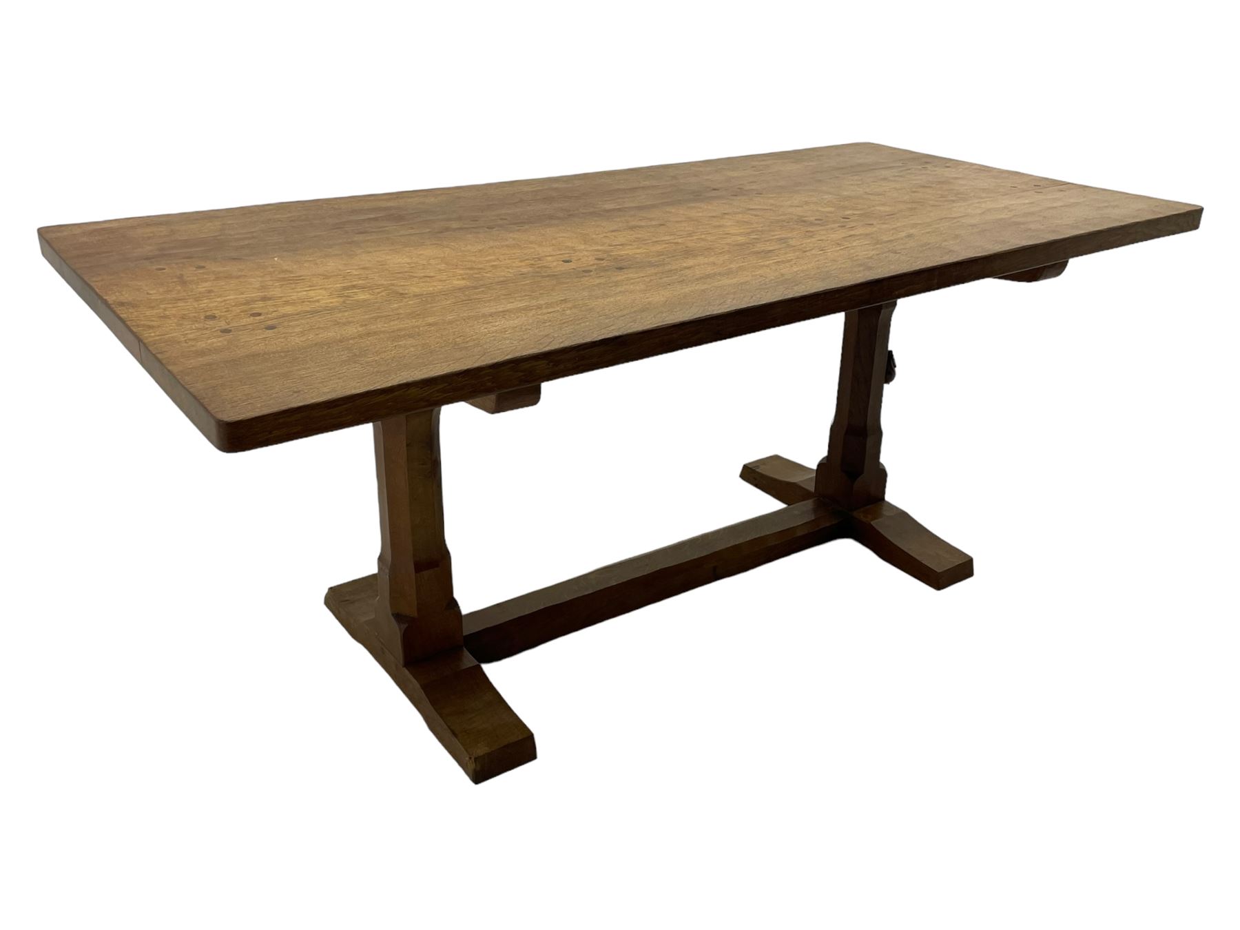 Rabbitman - oak dining table, rectangular adzed top, twin octagonal pillar supports on sledge feet, united by floor stretcher, carved with rabbit signature, by Peter Heap of Wetwang 