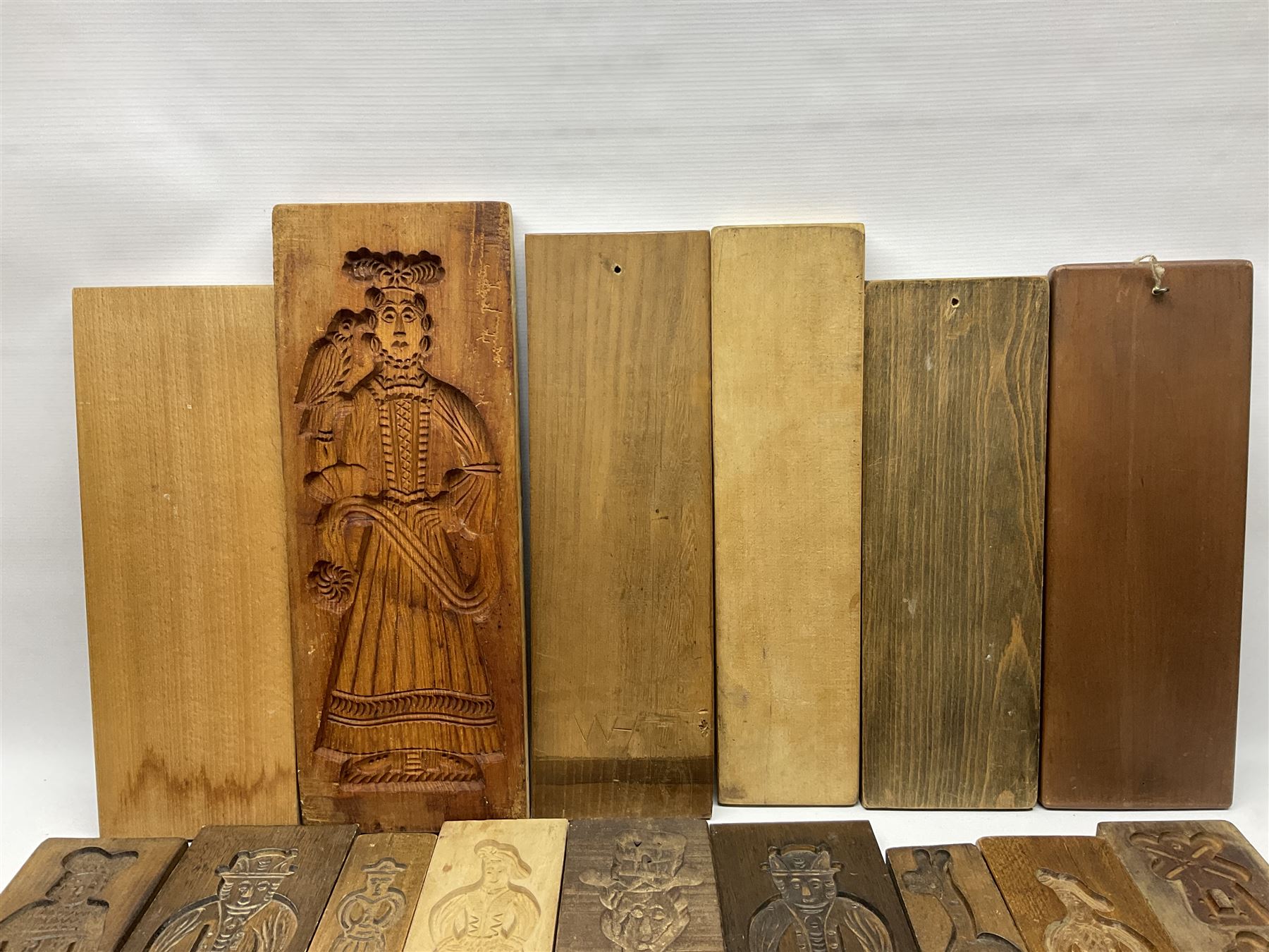 Collection of 20th century beech and other hardwood Dutch folk art Speculaasplank or biscuit moulds, most examples typically carved with figures in traditional dress, tallest H52cm