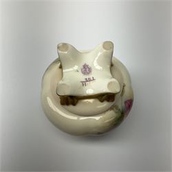 A small Royal Worcester potpourri jar and cover, shape 261, the bulbous body hand painted with pink roses, supporting a gilded and burnished pierced cover, upon four scroll feet, with puce printed mark beneath, H10.5cm.