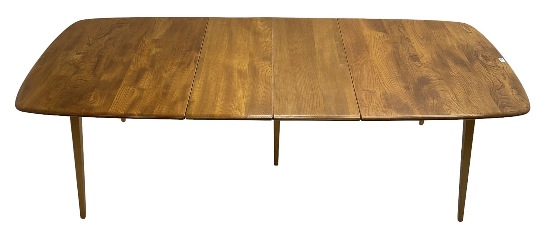 Ercol - light elm and beech 'Slide Leg Expanding Dining Table (444)', rectangular top with rounded corners, raised on tapered splayed supports, with two additional leaves