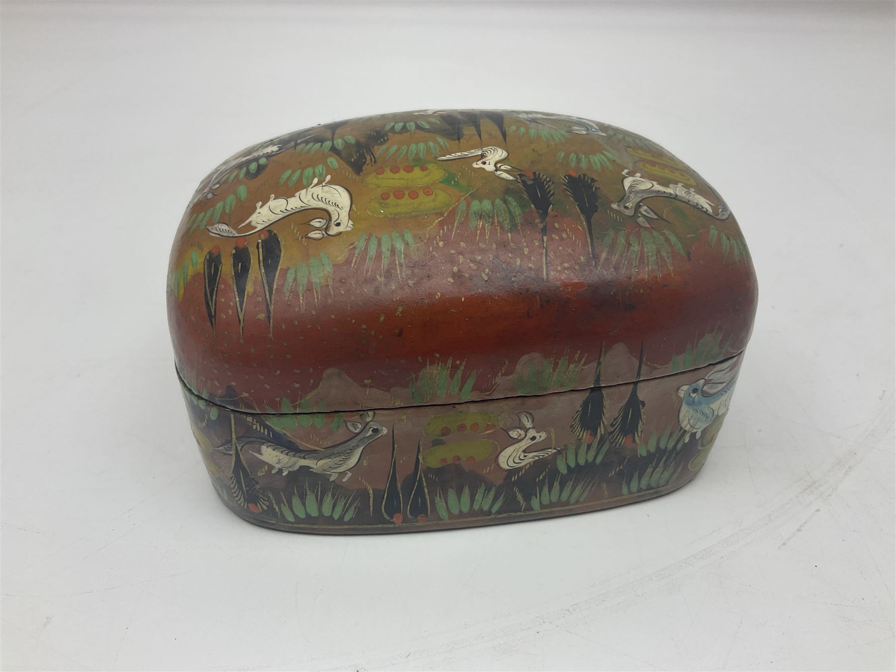 Nine lacquered boxes, all rectangular form, including russian examples decorated with animals within a stylized landscapes and example with flower decoration, largest H7cm, L11cm