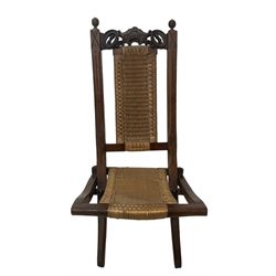 Victorian Aesthetic Movement mahogany framed folding campaign chair, pierced and carved cresting rail with carved and chamfered uprights, rattan back and seat