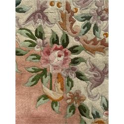 Chinese Aubusson design pink ground rug, the field decorated with an oval medallion filled with floral motifs in pastel shade, surrounded by floral garlands and foliate scrolls