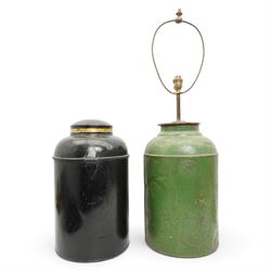 Two Victorian toleware shop display tea canisters, the first decorated in gilt with Chinese writing within laurel leaf borders and numbered 3, on black ground with hinged cover, H43cm, the second decorated in gilt with the number 8, within S scroll borders, on green ground, later converted to a table lamp, H81cm overall (2)