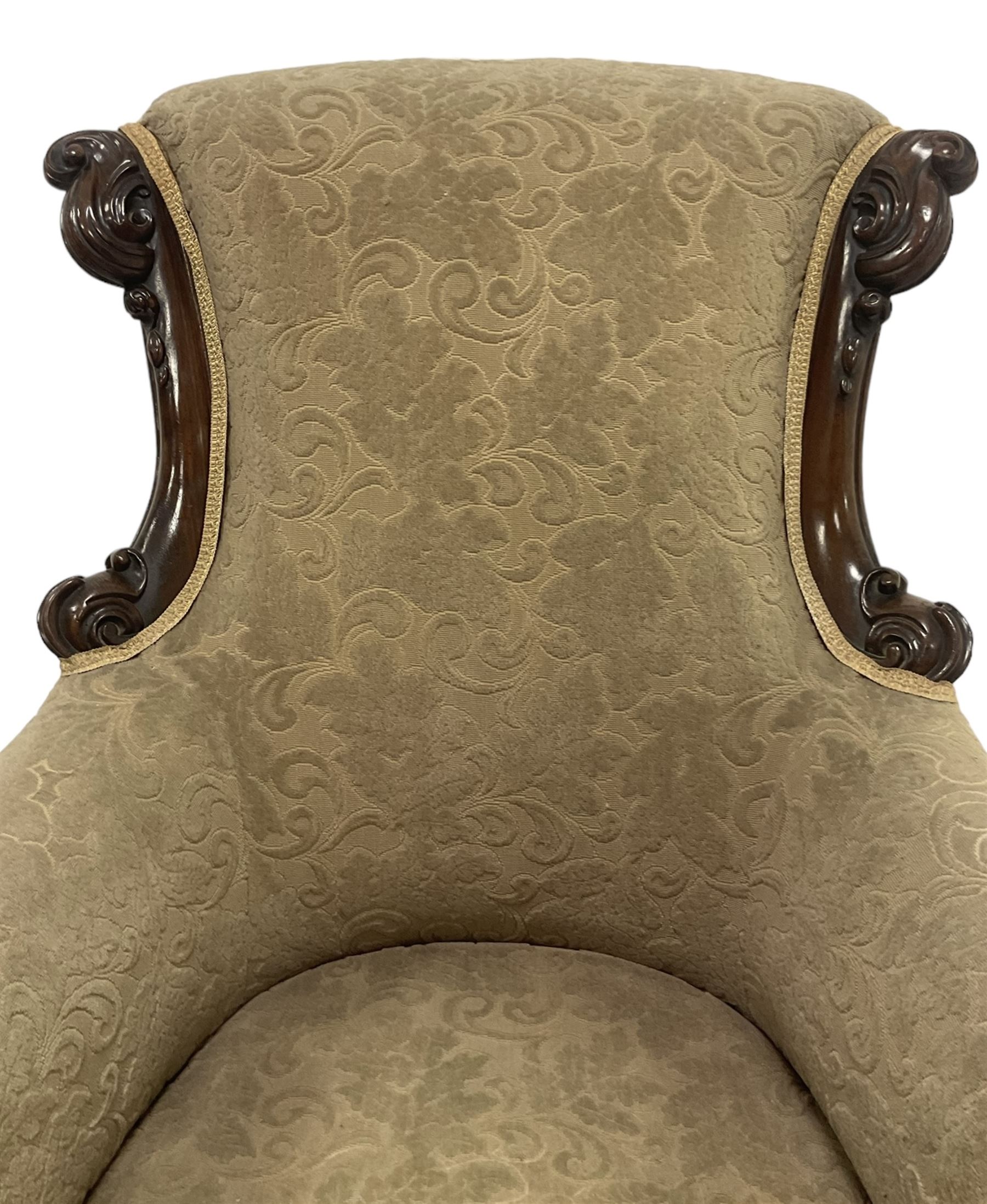 William IV mahogany framed armchair, rolled back with scroll carved uprights, acanthus carved arm terminals over serpentine fronted seat, raised on turned and lobe carved supports with castors