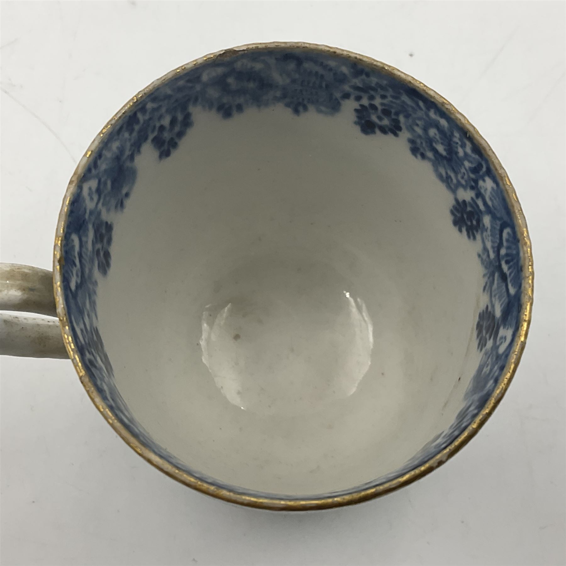 Rare 18th century Bow porcelain coffee cup, circa 1765-1770, profusely decorated with figures and dwellings in a rocky landscape, the interior with wide foliate border, H6cm