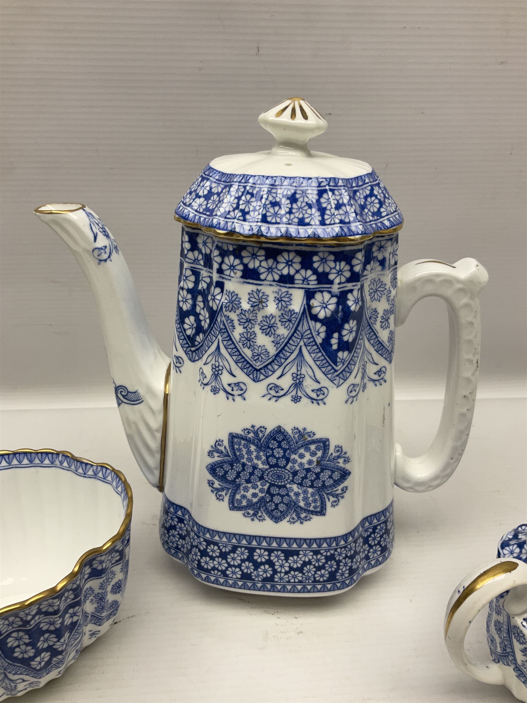 Late Victorian W T Copeland & Sons Primrose pattern coffee set for six, pattern no 2724, comprising coffee pot, milk jug, sugar bowl and six coffee cans and saucers, all upon a Lazy Susan, of circular form, with gilded rim and upon domed pedestal foot, with printed mark beneath, D44.5cm