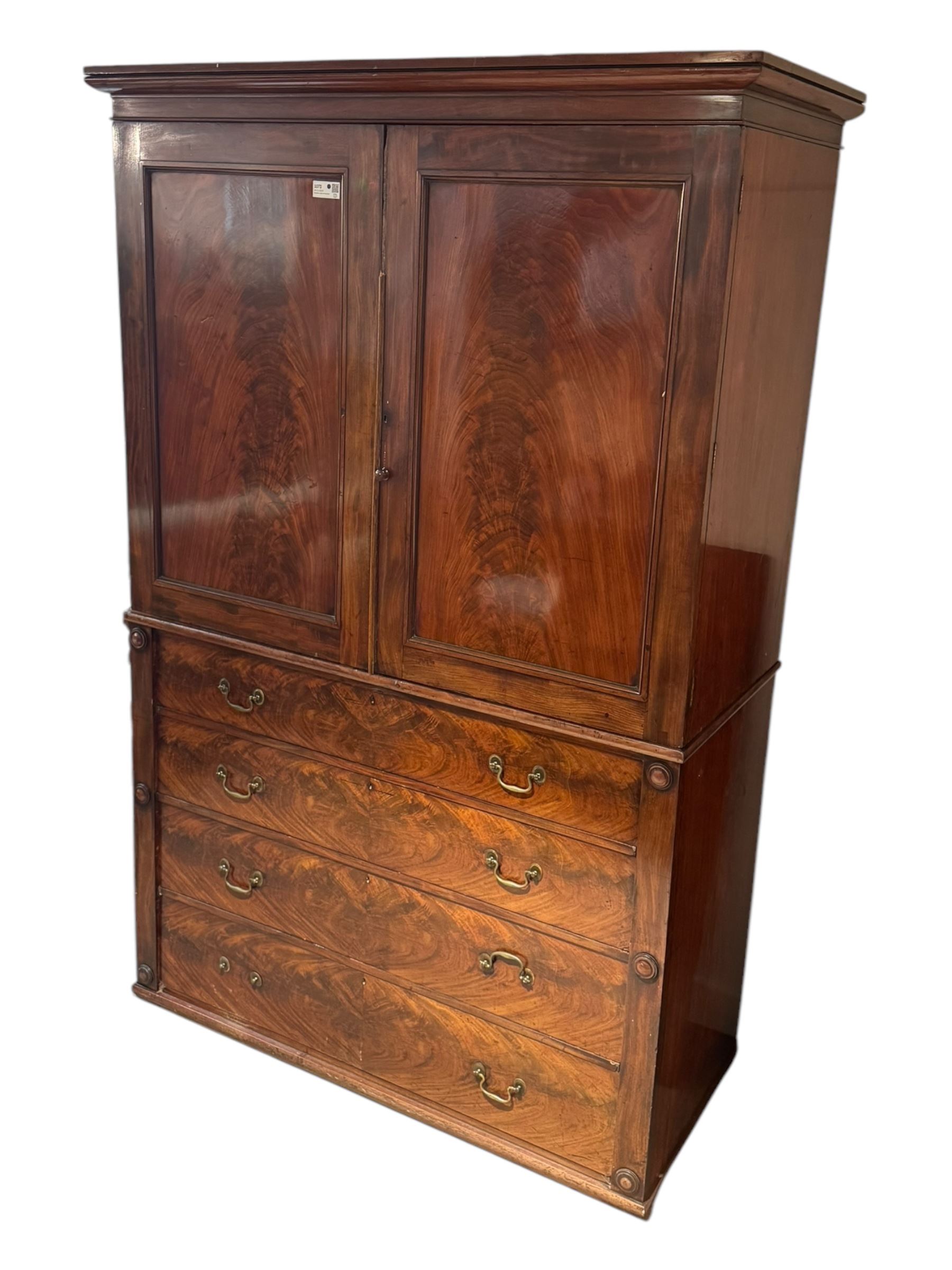 Victorian mahogany linen-press, moulded cornice over two figured panelled doors, the interior fitted with five slides and hanging rail, four long drawers below 