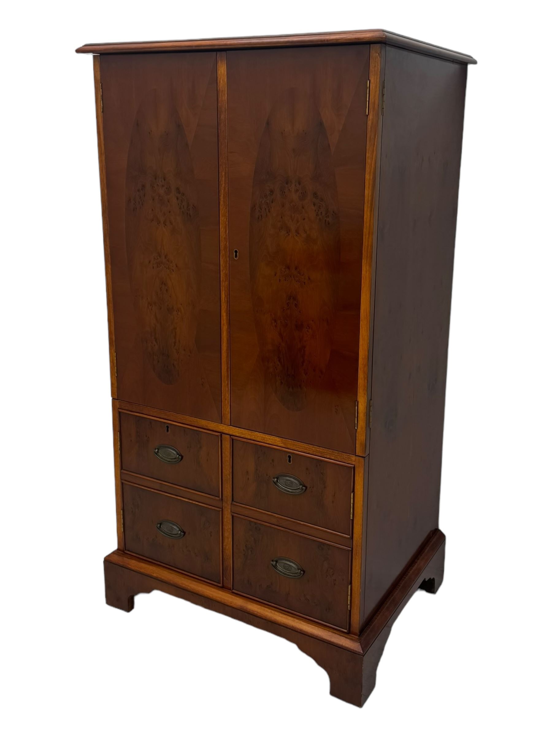 Wade - yew wood hi-fi cabinet, moulded rectangular hinged top over double-door cupboard with figured veneer, enclosing three adjustable shelves, lower section fitted with two cupboards to resemble four drawers, enclosing three drawers and open storage