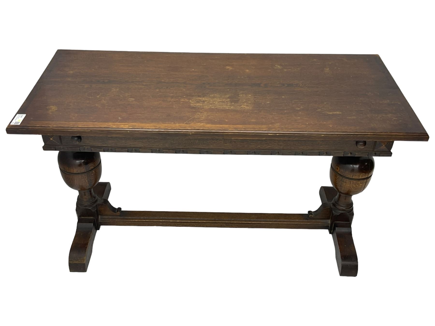 Early 20th century oak extending table, moulded rectangular top, pull-out action with fold-out leaf, on turned cup and cover pedestals and sledge feet, united by moulded stretcher 