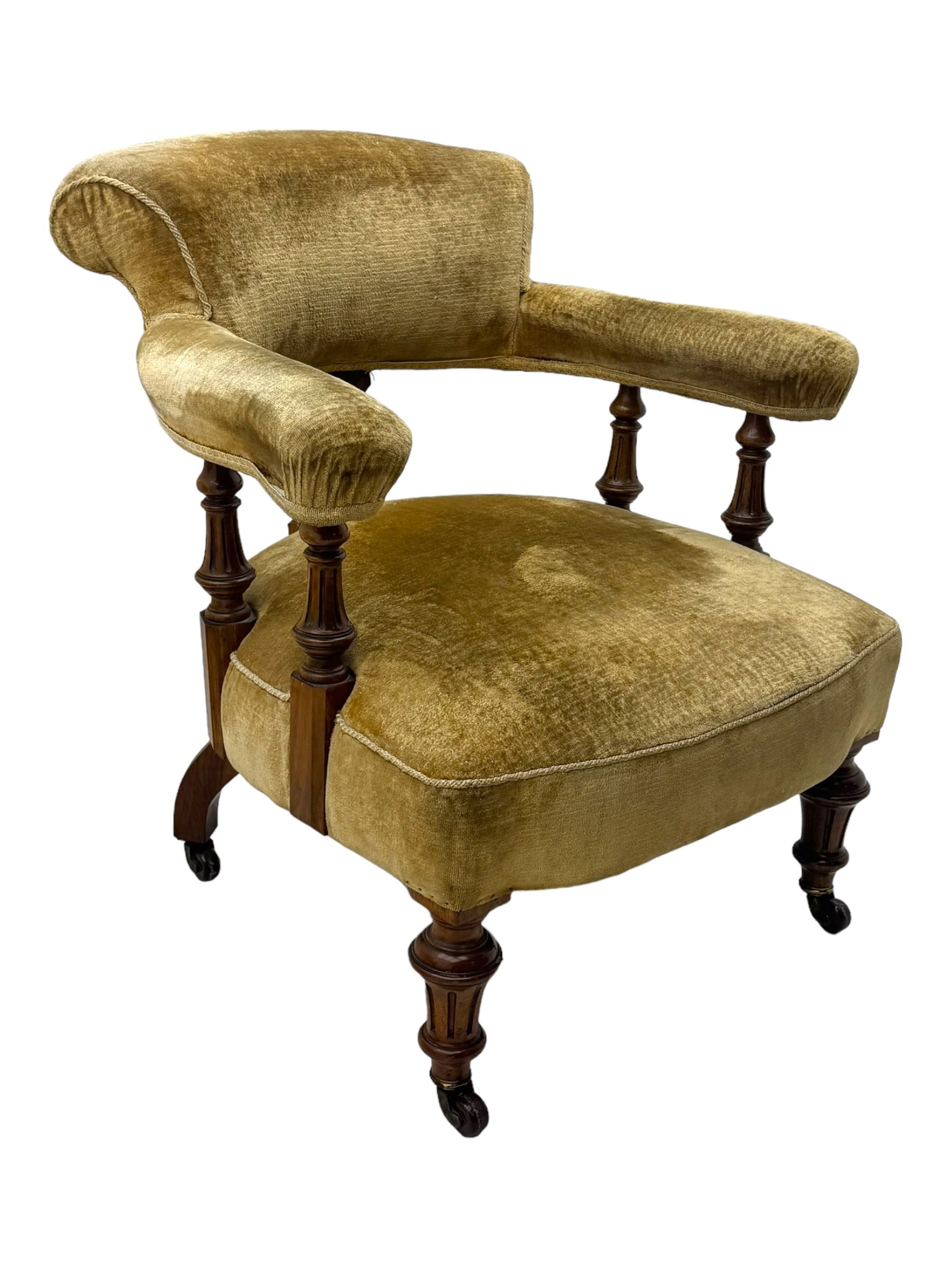 Victorian pair of mahogany armchairs, upholstered in gold velvet fabric, each with curved back, pierced splat and scroll arms, one with rounded seat and the other square, on turned front supports with castors