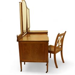 Waring & Gillow Ltd. - Edwardian satinwood dressing table, raised bevelled triple mirror back on square supports, over frieze inlaid with geometric stringing in ebony, moulded drop-centre table with stringing, fitted with seven drawers, reeded and foliate cast handles and square leaf cast handle plates, on square tapering supports terminating to brass castors, the centre drawer with metal maker's plaque and maker's stamp for 'Waring & Gillow, Ltd.', the top three drawers fitted with Chubb locks, the remaining drawers fitted with locks stamped 'Gillows Lancaster', together with associated chair 