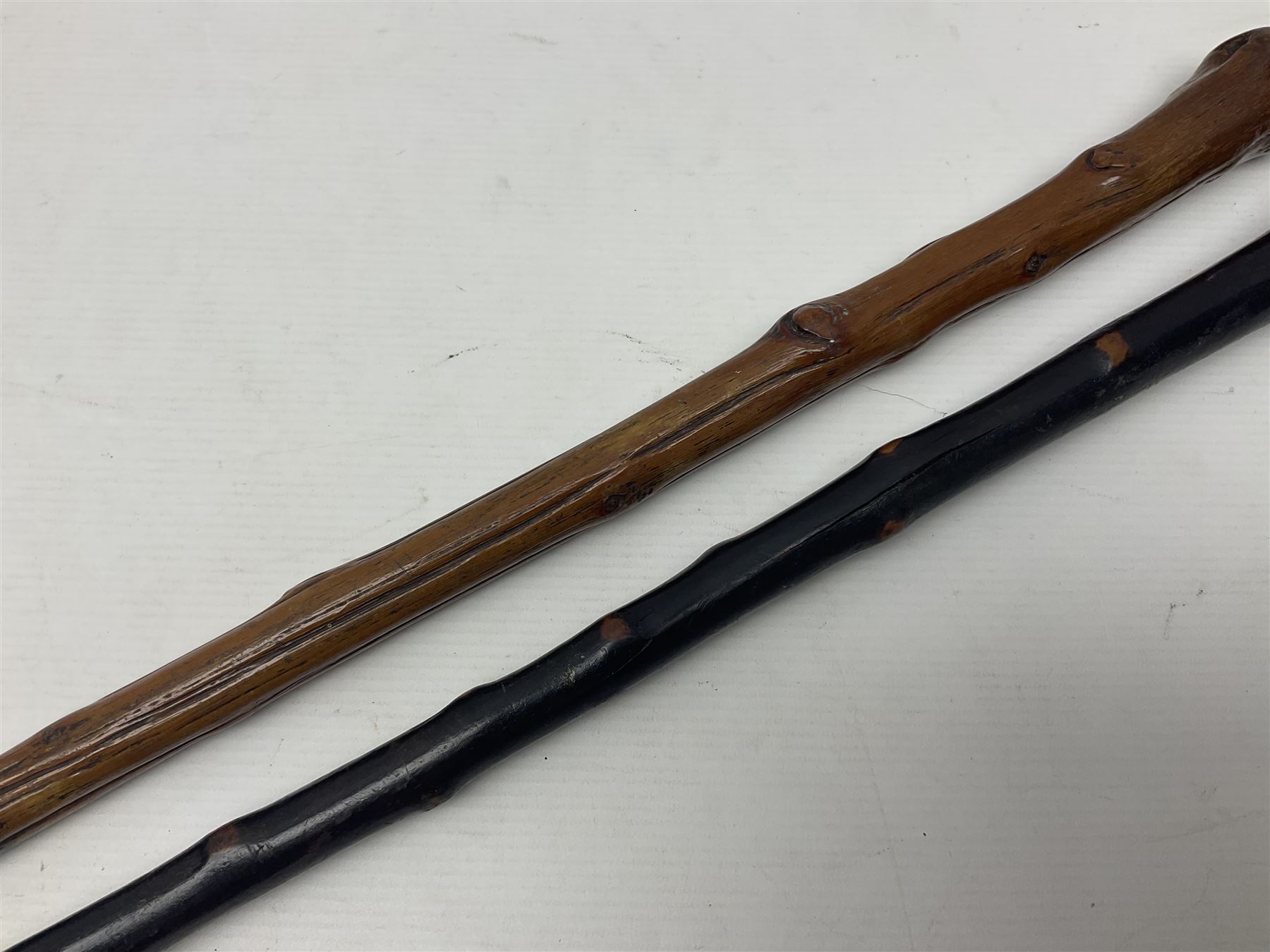 Two wooden walking sticks, both with comparts that would have housed horse measures, H88cm