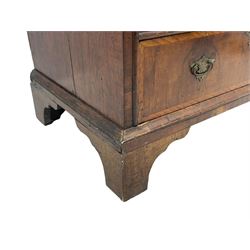 18th century oak and walnut chest, fitted with four small over three long drawers with figured walnut facias, brass handles and plates with engraved decoration, on bracket feet