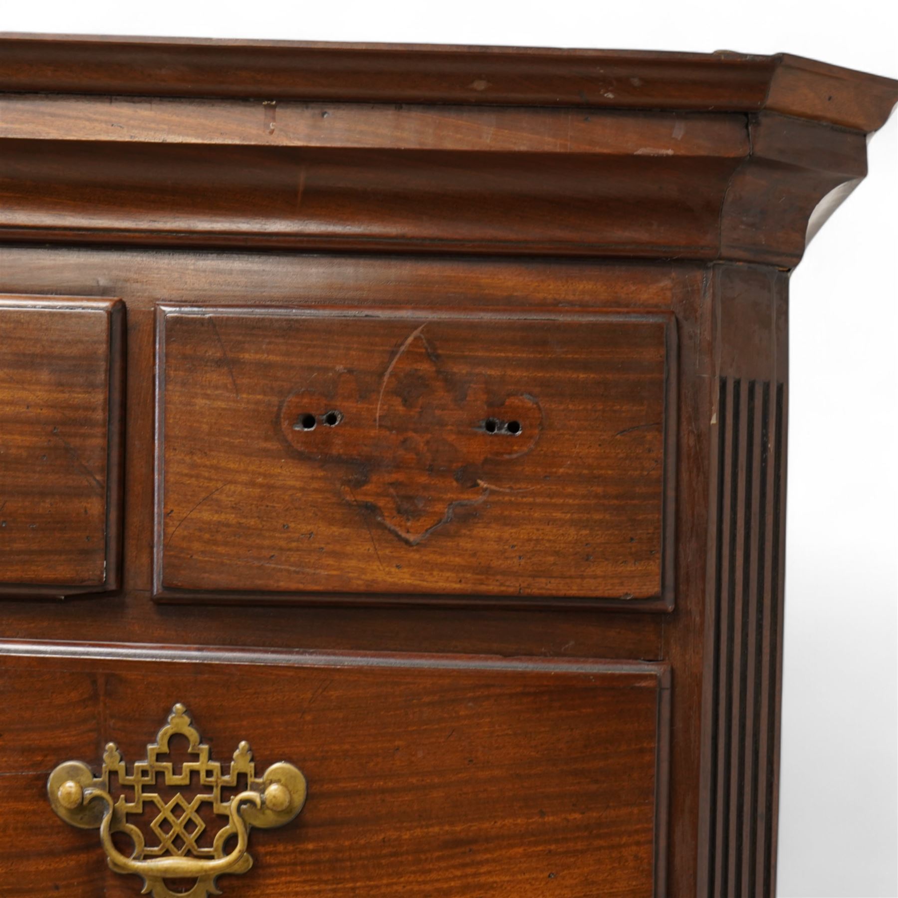 George III mahogany canted chest-on-chest, moulded cornice over three short and six long moulded drawers, shaped and pierced handle plates with swan neck handles, fluted upright canted corners, on bracket feet 