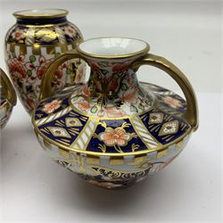 Pair of Royal Crown Derby 6299 imari miniature two-handled vases, together with another miniature vase of baluster form, all with printed mark beneath, tallest H8cm 