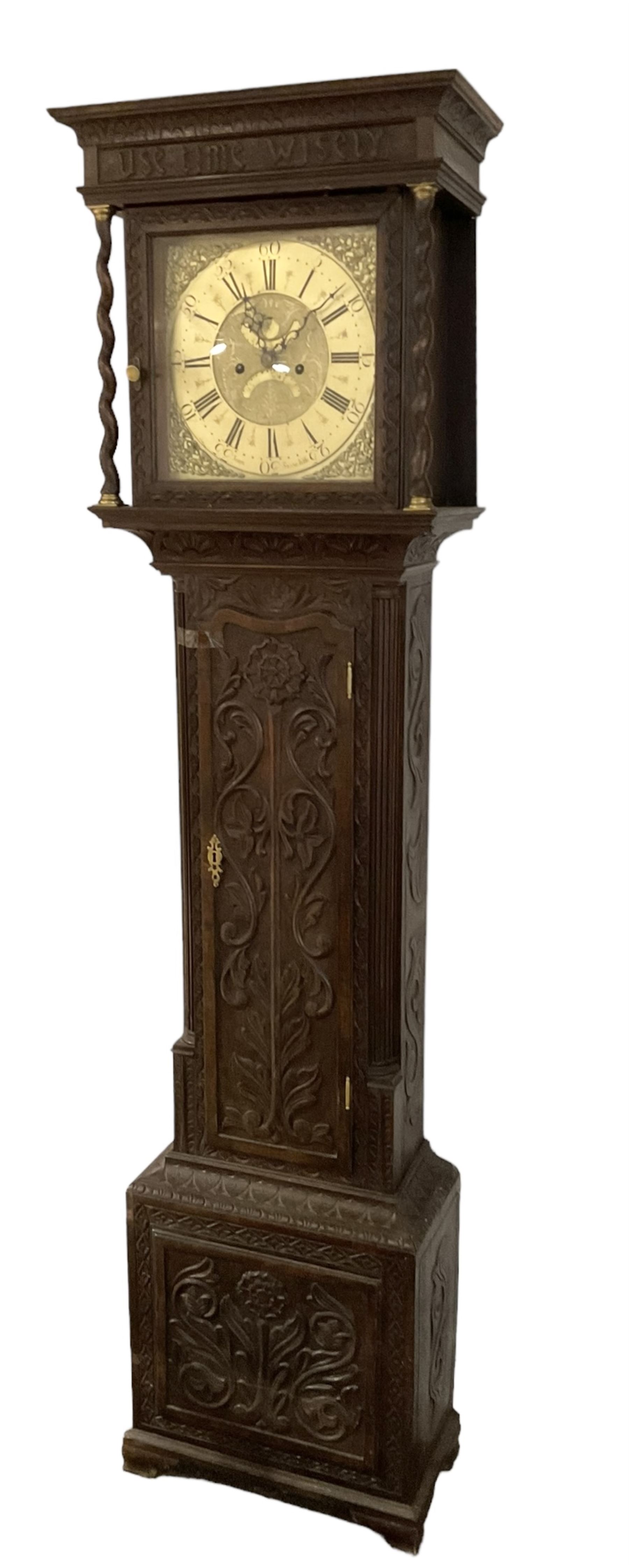 8-day - profusely carved oak longcase, with a flat top and square hood door beneath, door flanked by barley twist columns with brass capitals, trunk with reeded quarter columns and wavy topped door, on a carved plinth raised on bracket feet, brass dial with an engraved and matted dial centre, penny moon and date aperture, chapter ring inscribed “John Stancliffe” with Roman numerals and five-minute Arabic's, rack striking movement with a recoil anchor escapement. With pendulum and weights.