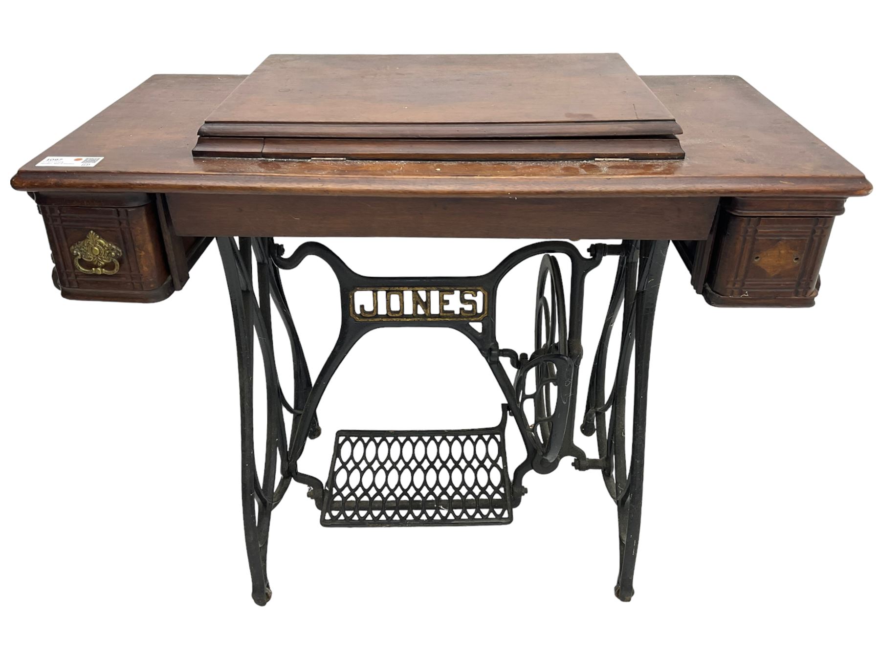 Early 20th century Jones treadle sewing machine table, bevel edged rectangular top with hinged lid enclosing sewing machine no. 480760, supported by cast iron treadle base