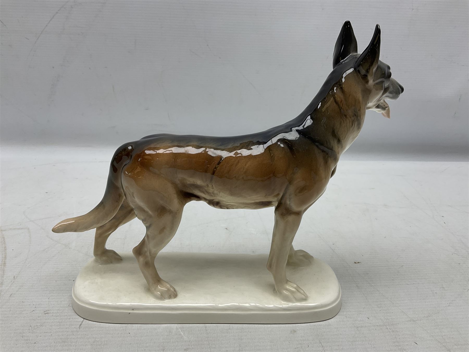 Two Hertwig and Co Katzhutte figures of dogs, comprising a German Shepherd and a pointer dog, both with printed marks beneath, largest H21.5cm W25cm