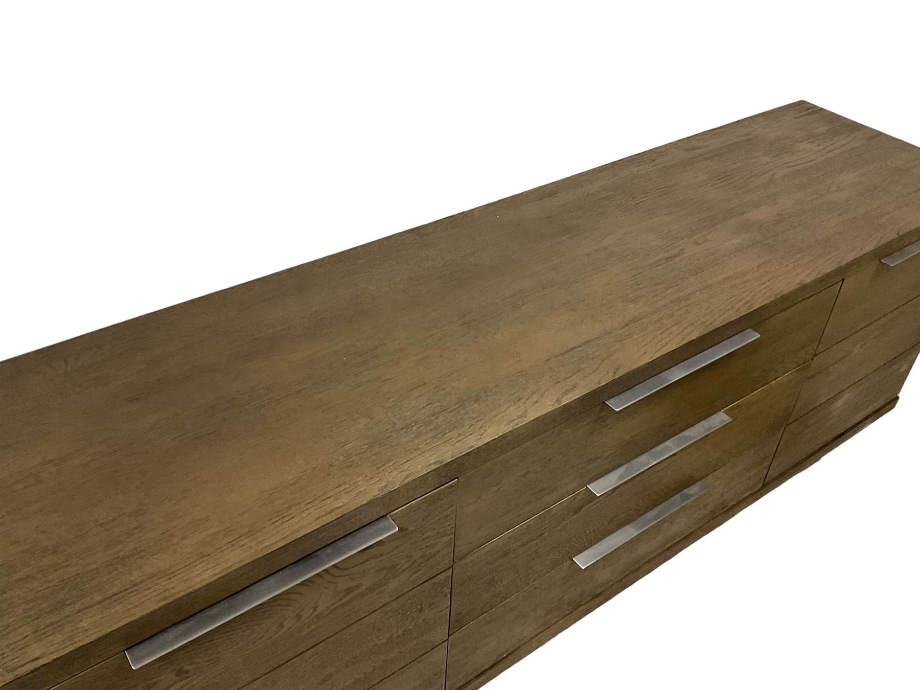 Contemporary dark oak finish sideboard, three central drawers flanked by single cupboards, on angular black finish metal supports 