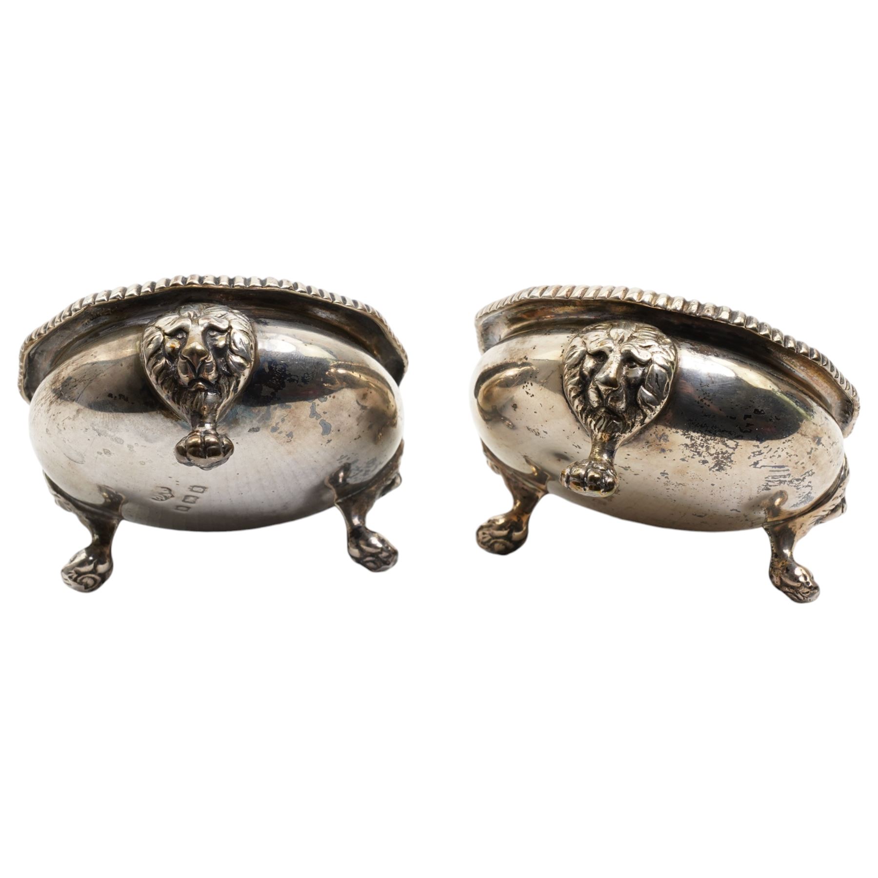 Pair of early 20th century silver salts, cauldron form with gadrooned borders, upon three lion mask and paw feet Birmingham 1917 Maker Wilson & Gill, 