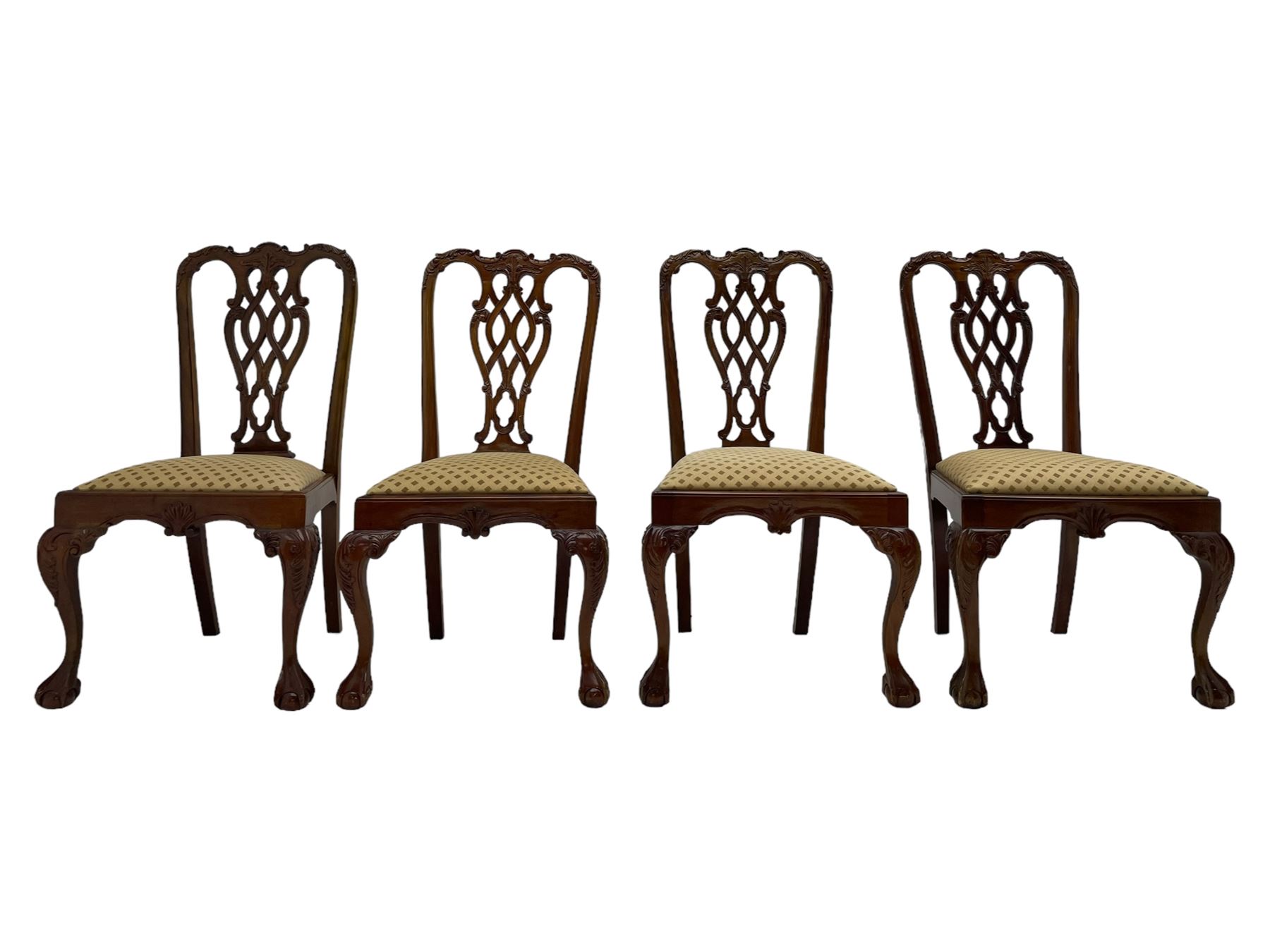 Set of twelve Chippendale design mahogany dining chairs, shaped cresting rail carved with foliage and C-scrolls, pierced interlaced splat with curled leaf decoration, upholstered drop-in seat, moulded seat rails, on scrolled acanthus carved cabriole supports with ball and claw feet 