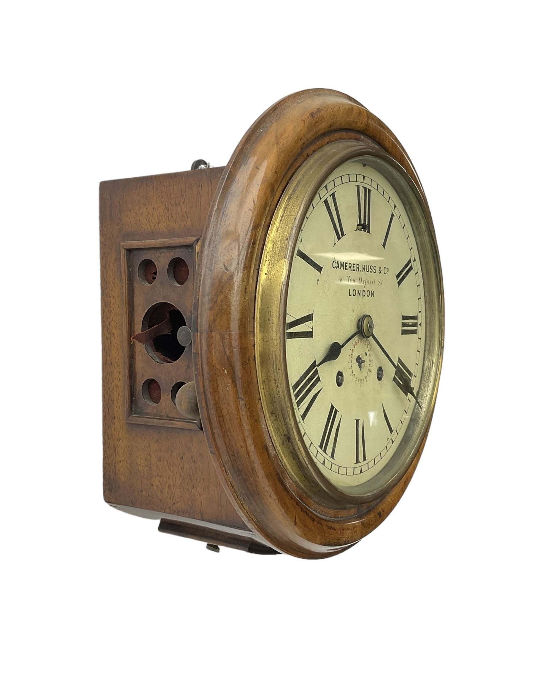 Camerer Kuss & Co -  8-day wall clock with alarm, mahogany dial surround and brass bezel, 8