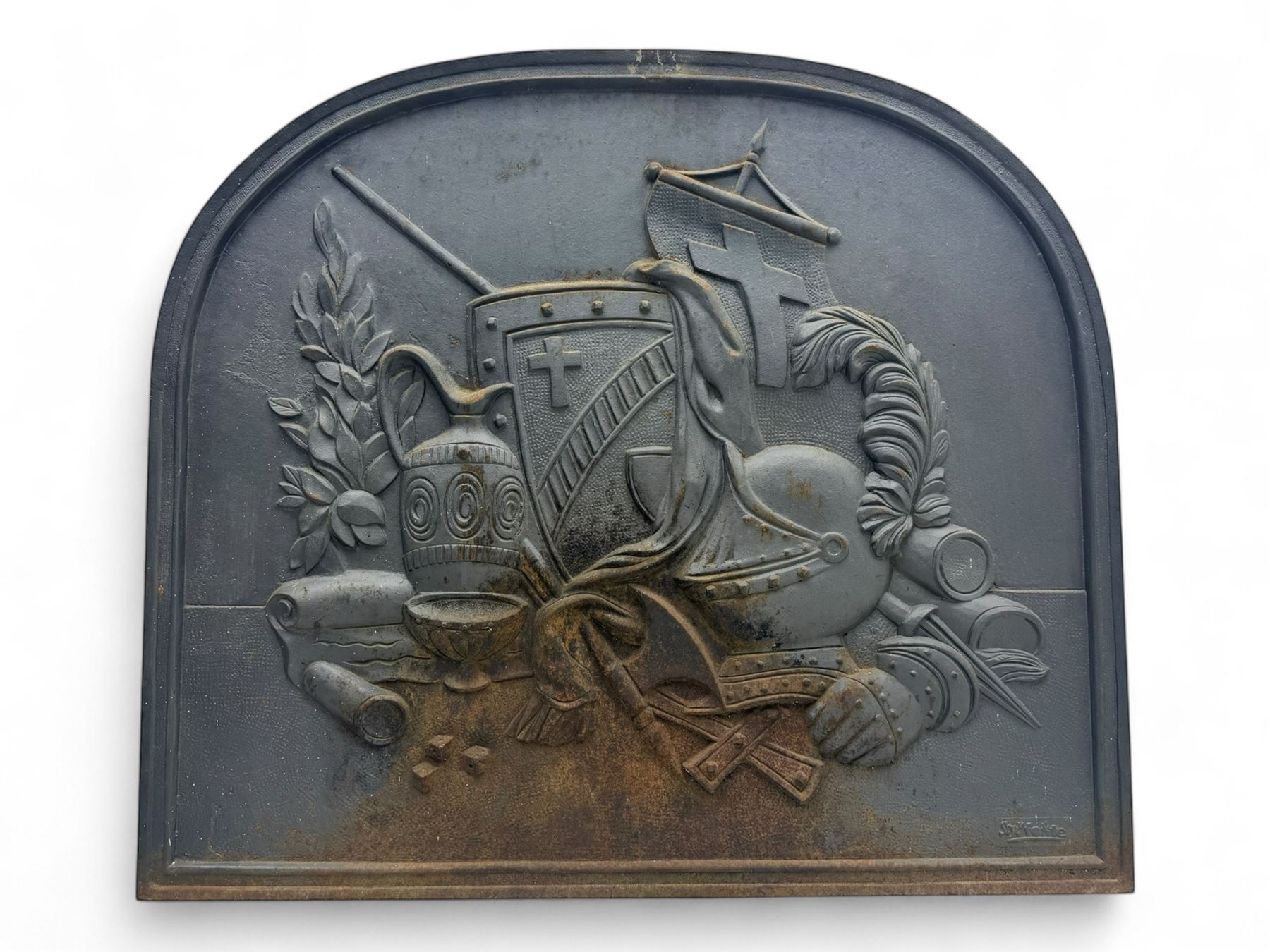 French cast iron fireback, arched form with relief of medieval armour and heraldic symbols, including a shield with a cross and a plumed helmet