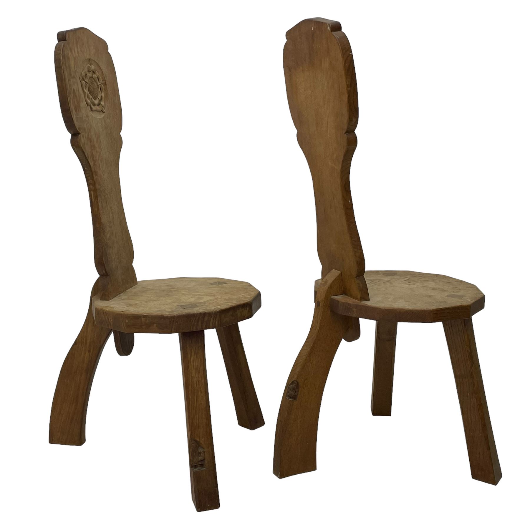 Gnomeman - two oak spinning or hall chairs, shaped splat backs, one carved with Yorkshire Rose, the other with mythical dragon, decagon seats on chamfered square tapering supports, each carved with gnome signature, by Thomas Whittaker, Littlebeck