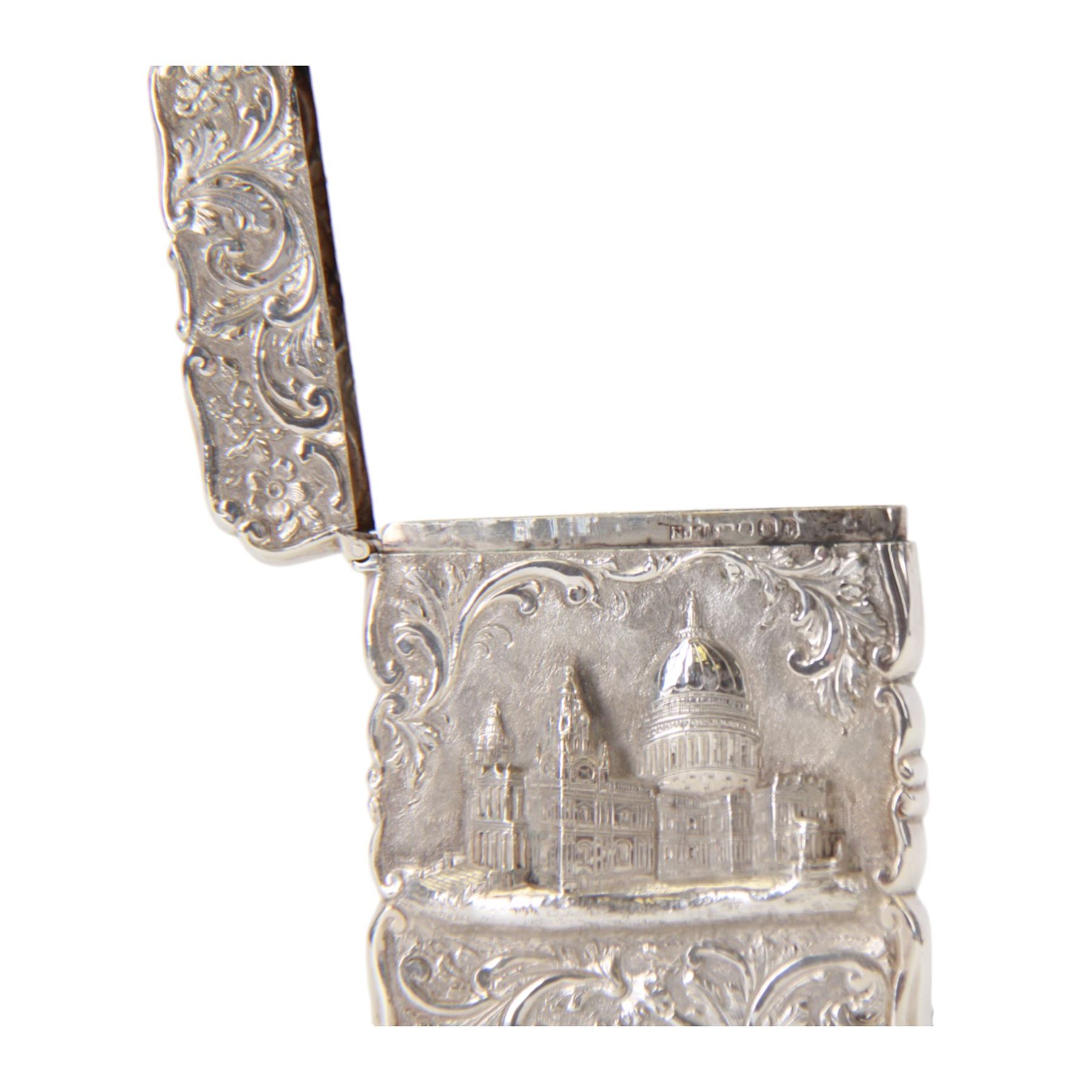 Victorian silver castle-top card case, of rectangular form with scrolling sides, relief embossed with the St Paul's Cathedral and surrounded by foliate scrolls, with vacant cartouche to reverse, hallmarked Nathaniel Mills, Birmingham, probably 1847, H8.5cm W6cm
