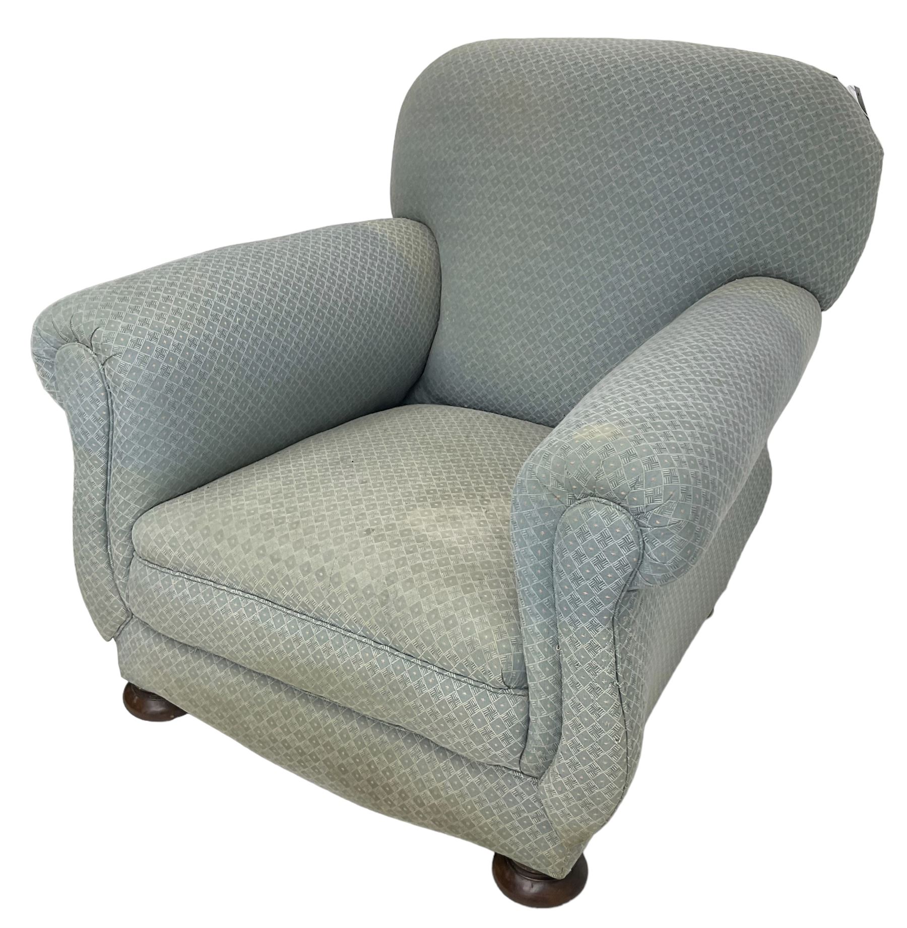 20th century traditional shape armchair, curved back and rolled arms, upholstered in light blue patterned fabric, on turned front feet