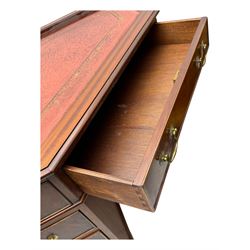 Late 20th century mahogany corner desk, leather inlaid top with gilt tooling, central frieze drawer flanked by two banks of four graduated drawers, raised on shaped bracket supports 