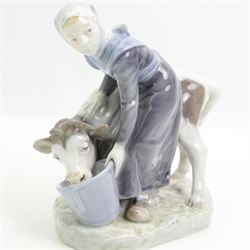 Royal Copenhagen figure of a girl feeding a calf No.799 H16cm, Copenhagen cobalt blue vase decorated with crocus H12cm, Copenhagen penguin No.3003 and a Bing & Grondahl pig