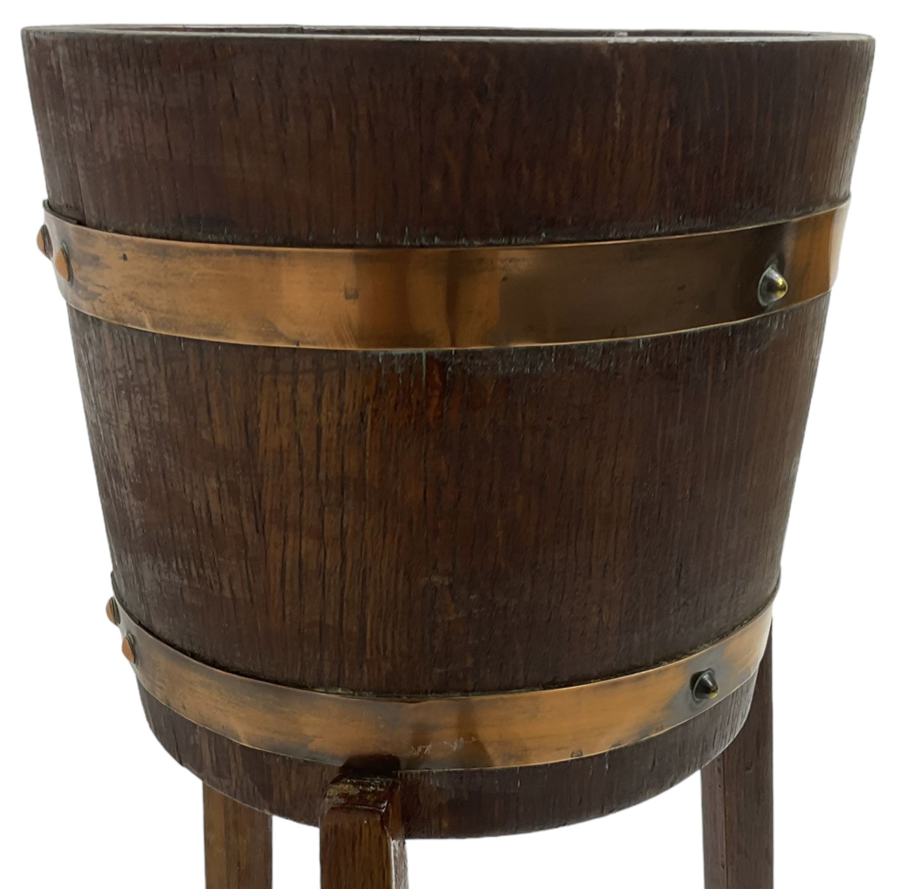 RA Lister & Co, Dursley - early 20th century oak jardinière plant stand, coopered barrel on three splayed supports united by undertier 