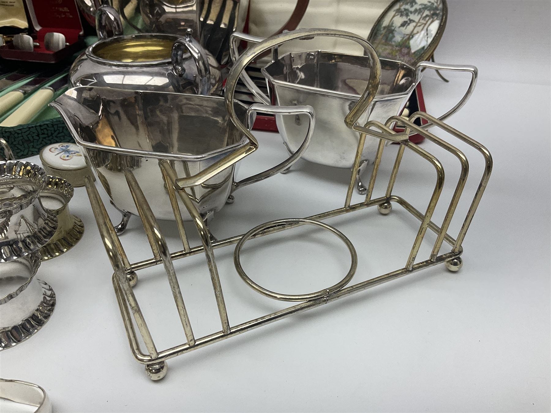 Silver plated four piece tea service, comprising teapot, coffee pot, open sucrier and milk jug, together with card case embossed with animals, flatware etc, 