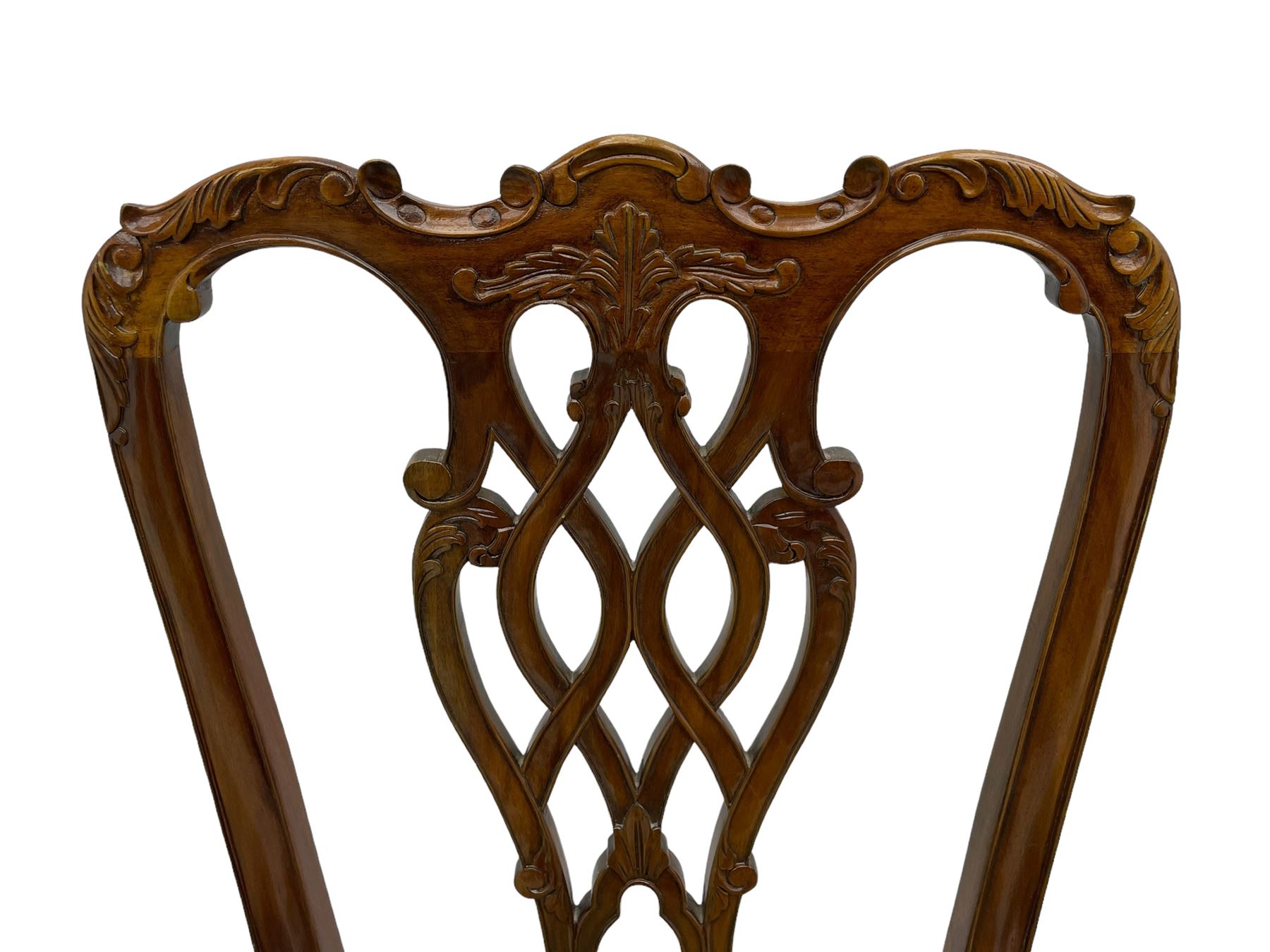 Set of twelve Chippendale design mahogany dining chairs, shaped cresting rail carved with foliage and C-scrolls, pierced interlaced splat with curled leaf decoration, upholstered drop-in seat, moulded seat rails, on scrolled acanthus carved cabriole supports with ball and claw feet 