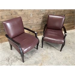 Two rosewood framed armchairs, upholstered in brown leather