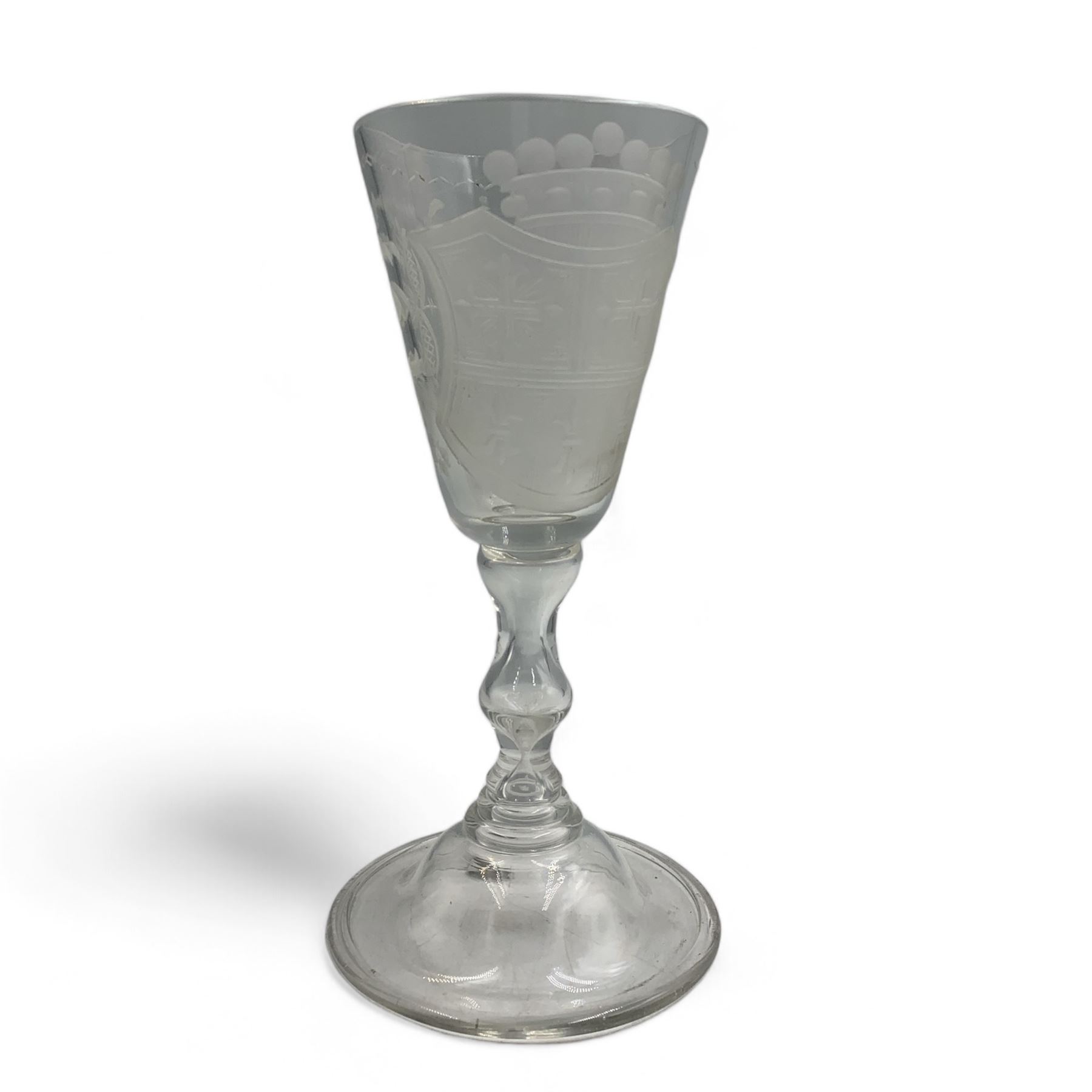 18th century large baluster wine glass, circa 1745, the funnel bowl decorated with a crest and foliate, to a knopped stem and deep domed  and upturned foot, H20cm