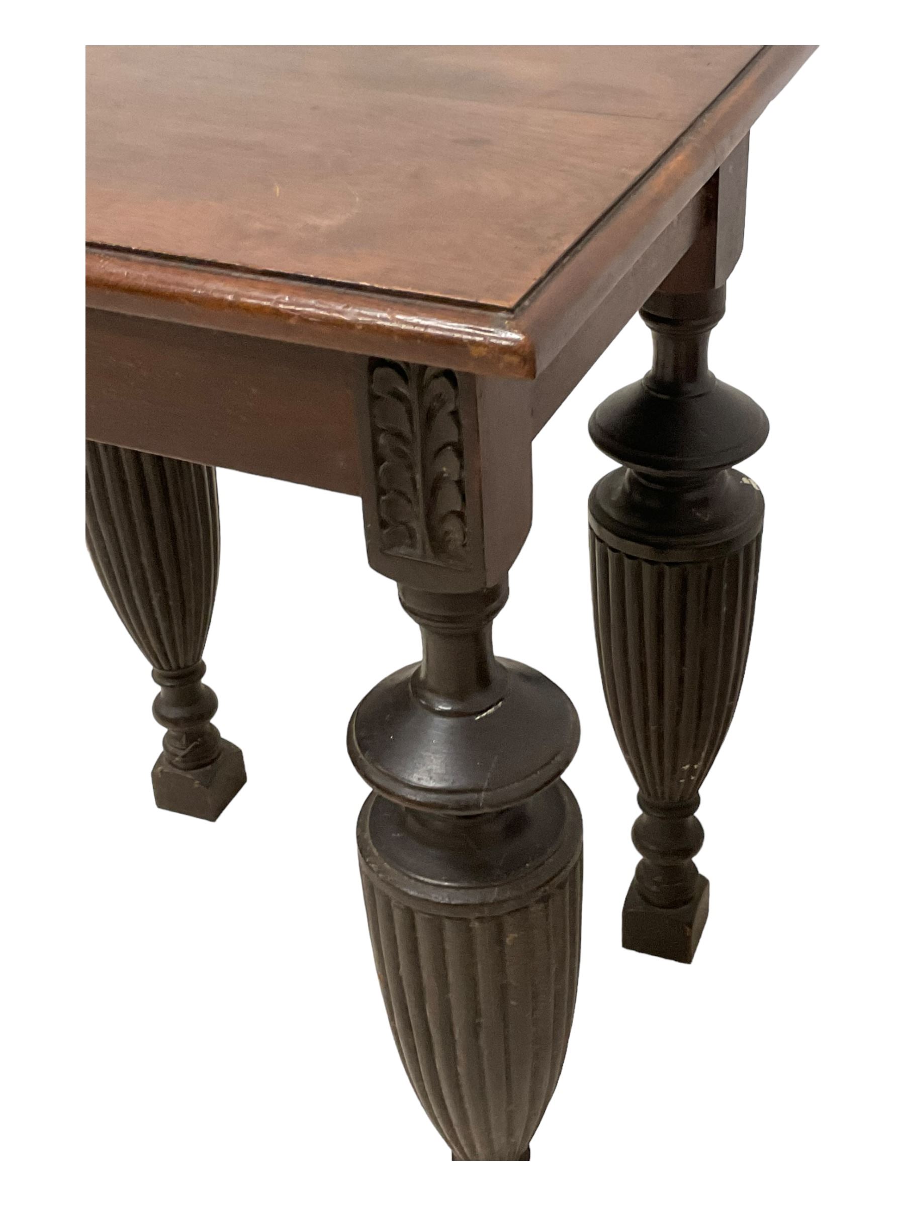 Late Victorian walnut nest of three tables, rectangular top with moulded edge, raised on reeded and turned urn shaped supports with acanthus leaf carving and square feet