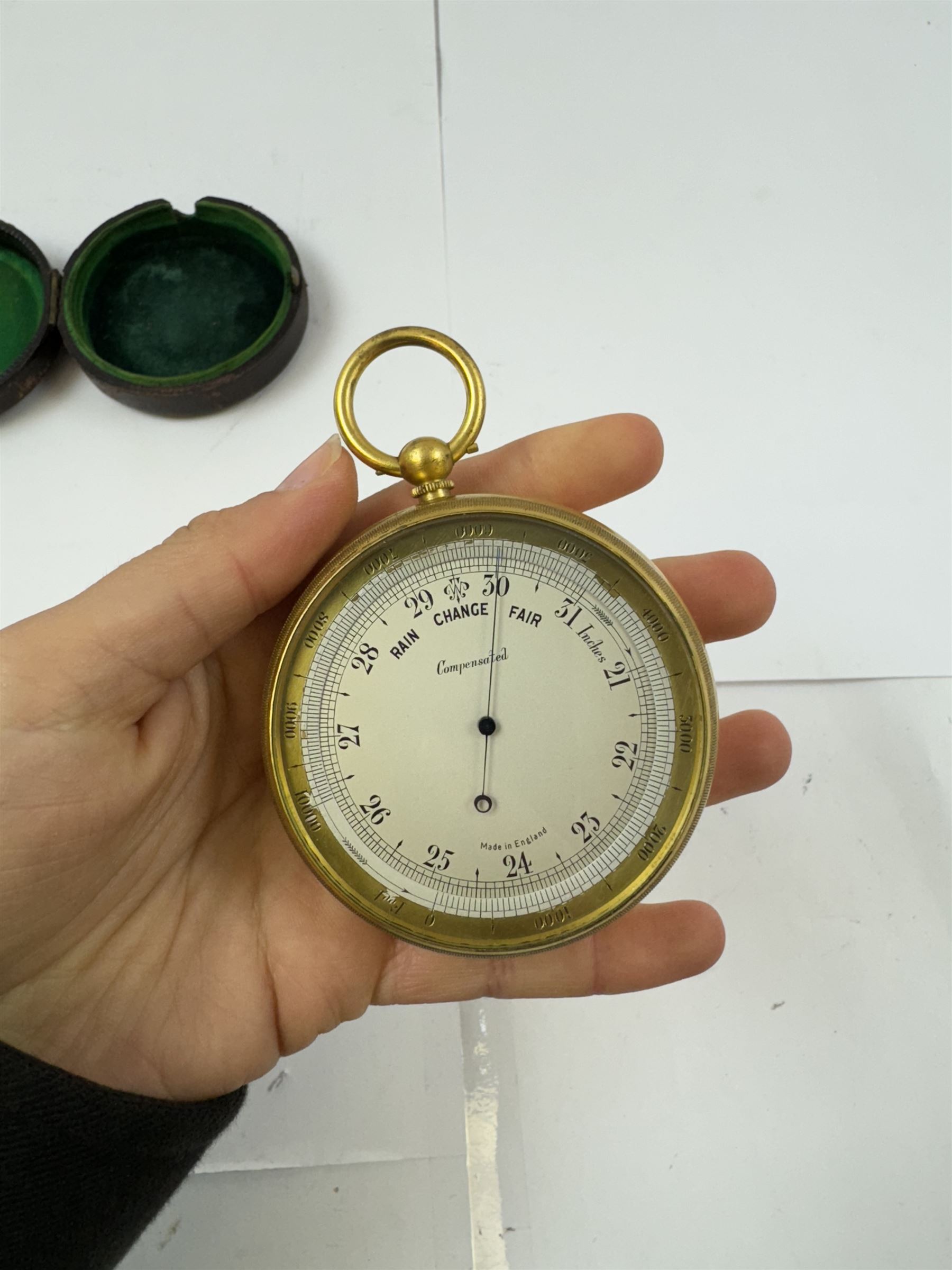 Lowdon Dundee, an early 20th century leather cased pocket barometer with silver dial, D4cm, together with another larger and later example, both cased