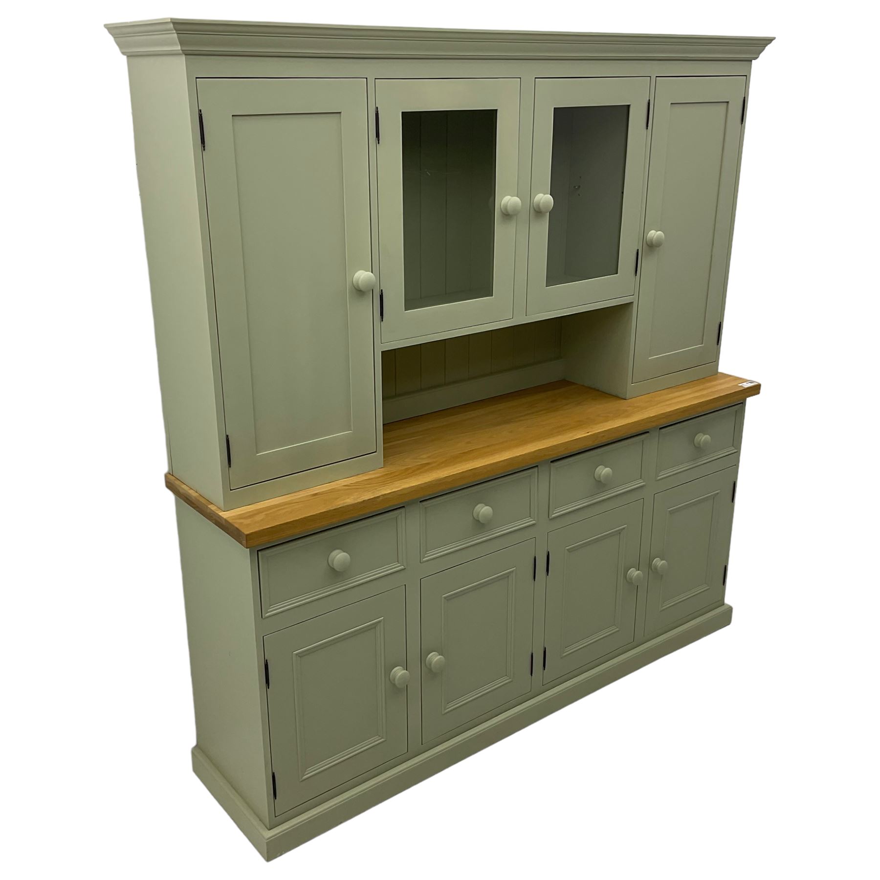 Painted kitchen dresser, projecting moulded cornice over central glazed display doors and flanking panelled cupboard doors, polished oak rectangular top over four drawers and four cupboards, on moulded plinth base, in laurel green paint finish 