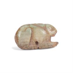 Ancient amulet, probably bone, carved as a rabbit with ears flatted against back, and incised eye, nose and mouth, L3cm