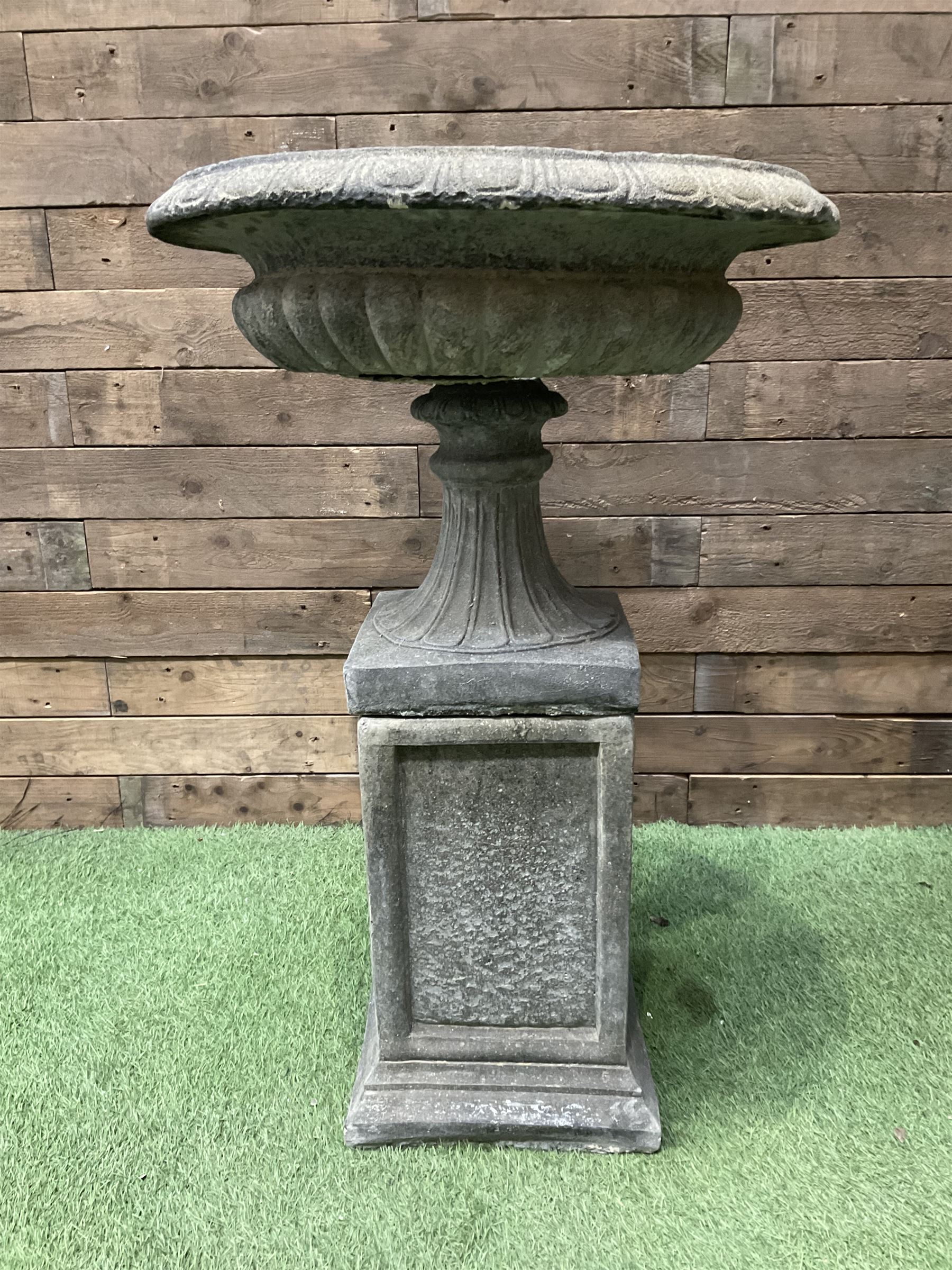 Pair of Victorian design cast stone squat garden urns, egg and dart border, raised on pedestal base and square fielded plinth - THIS LOT IS TO BE COLLECTED BY APPOINTMENT FROM DUGGLEBY STORAGE, GREAT HILL, EASTFIELD, SCARBOROUGH, YO11 3TX