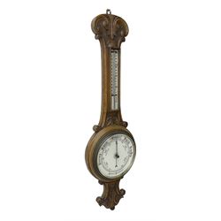 Edwardian - carved oak aneroid barometer, with a rounded top carved with scroll work, 8