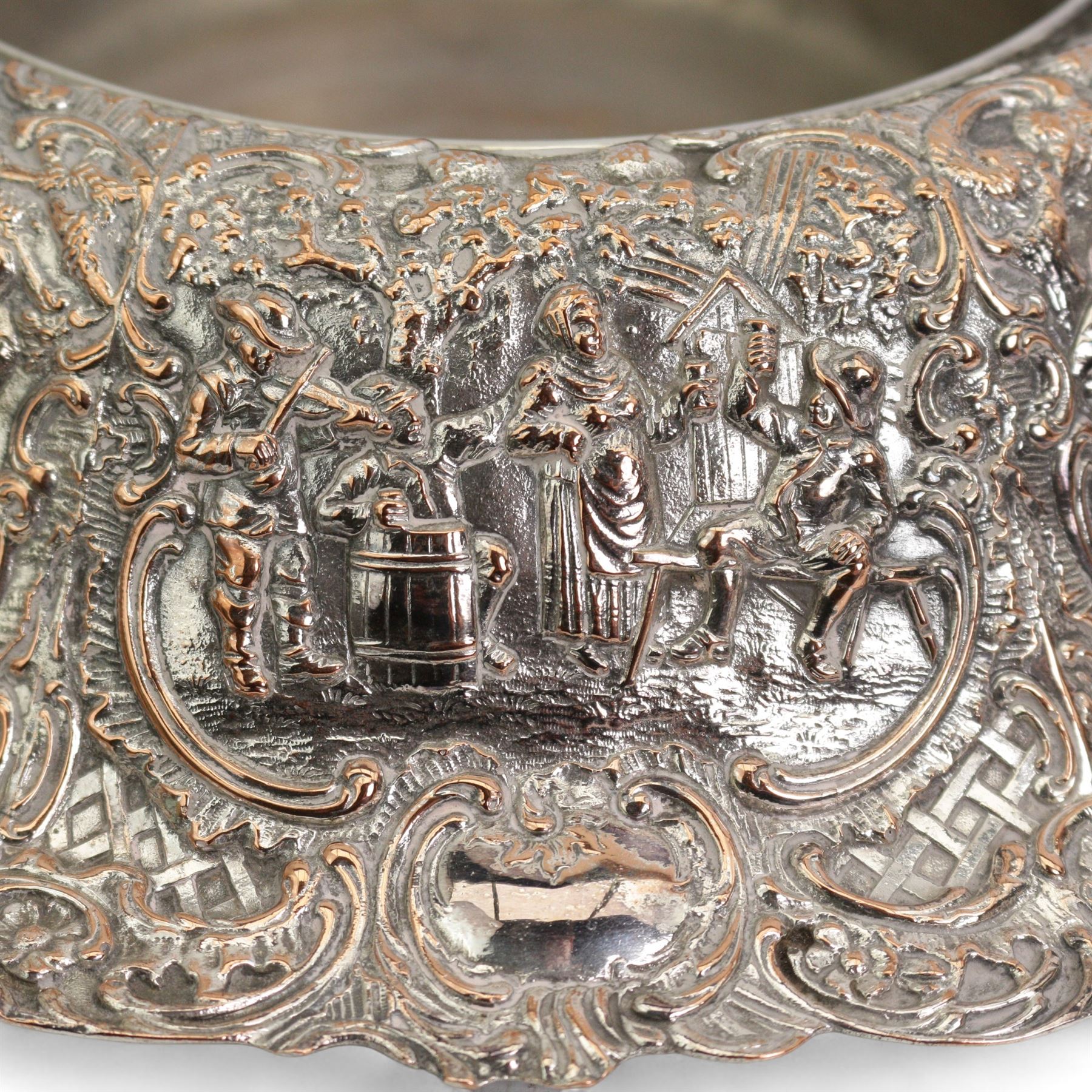 Large 19th century silver plate on copper circular table centre bowl, repousse with tavern scenes, D37.5cm, together with two pairs of silver plate on copper bottle coasters 