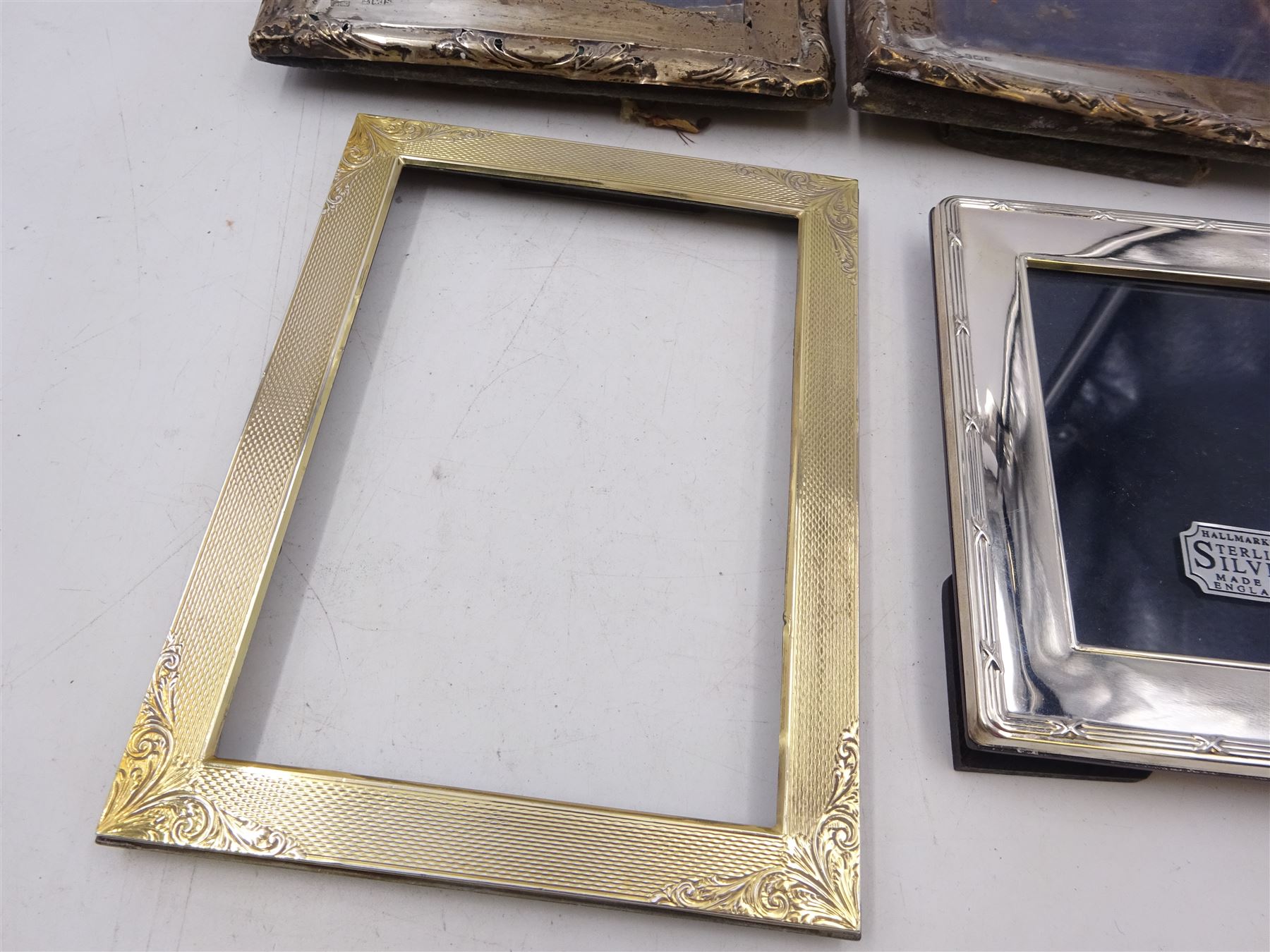 Four silver mounted photograph frames, comprising pair of early 20th century examples, and two smaller modern examples, all hallmarked, tallest H19cm