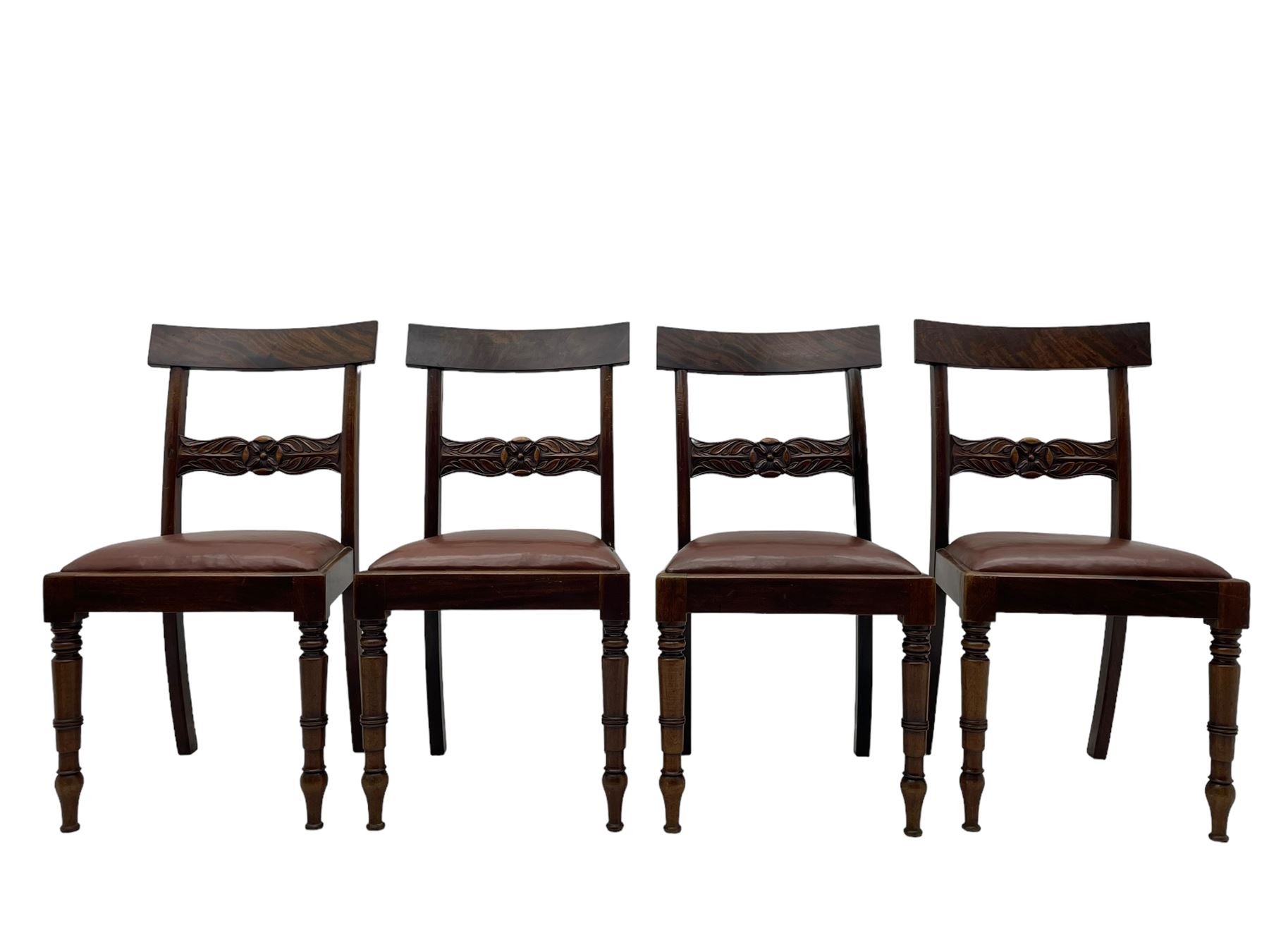 Set of six (4+2) early 19th century mahogany dining chairs, figured bar back over rose and curled leaf carved middle rail, drop-in seats upholstered in brown fabric, on turned front supports 